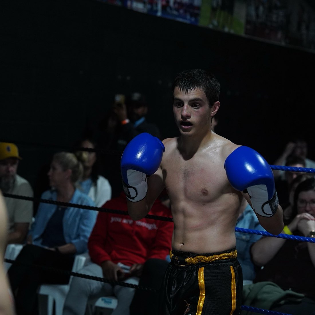 A Noble Fight fighter with gloves up in the ring