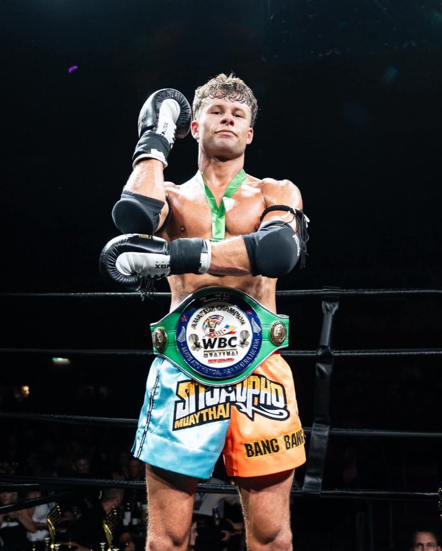 Muay Thai coach Julian Jensen wearing his WBC Muay Thai title belt