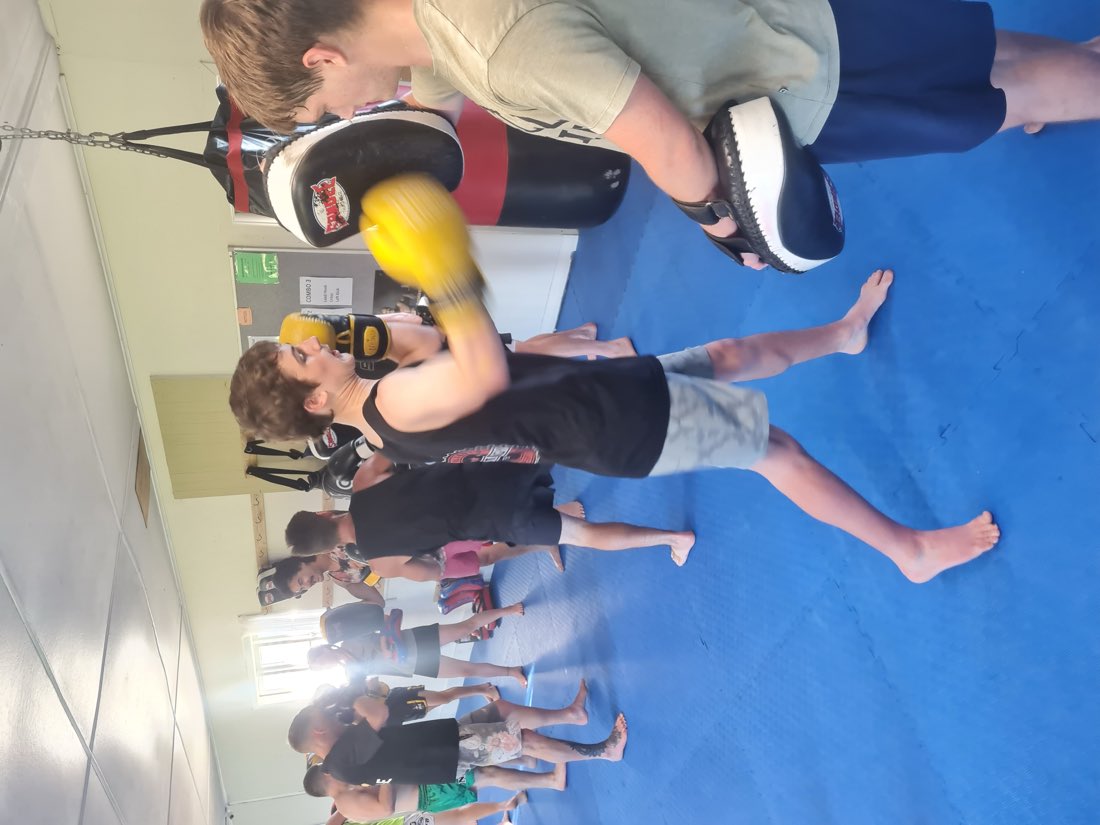 Members drilling punches on pads in a Basics class